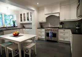 This gorgeous kitchen is fitted with dark gray kitchen cabinets, black hardware and matching black countertops. Kitchen With White Cabinets Trendy Kitchen Tile Kitchen Floor Tile Kitchen Design