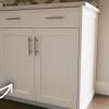 Professional installers vary greatly in their methods of fastening countertops to base cabinets. 1