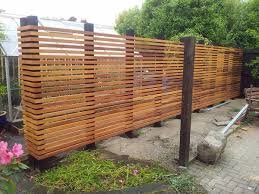 Darkly painted wooden garden fence. 24 Best Diy Fence Decor Ideas And Designs For 2021
