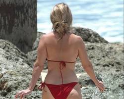 Image of Alice Eve in a bikini on a beach