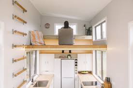 The bedroom loft is small, but well lit from large windows on both sides as well as a set of skylights located directly overhead. This Ingenious Tiny House Saves Space With A Lofted Office And Underfloor Storage Dwell