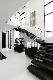 Black And White House Interior The Focal Point Is The Black Stairs This Space Has Good Contrast Between The Black And White The Shapes Modern House Design Dream Home Design House Interior