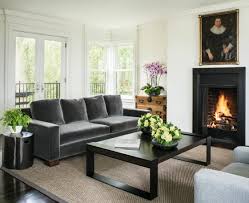 Visual interest is abundant in this small living room interior, from the golden leather ottomans to the glass and driftwood coffee table. How To Decorate My Living Room Living Room Decor For Beginners