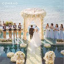 Exchange Wedding Vows On The Idyllic Tropical Beach High Above The Lush Forests And White Beaches O Water Wedding Ceremony Pool Wedding Wedding Venues Beach