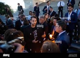 Itay Raviv, left, talks with Speaker of the United States House of  Representatives United States Representative Mike Johnson (Republican of  Louisiana), right, as Congressional Members are joined by family members of  Israeli