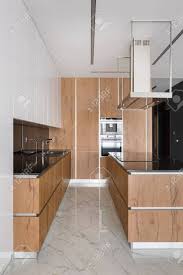 Maybe you would like to learn more about one of these? Stylish Kitchen With Wooden Furniture Kitchen Island And Marble Floor Tiles Stock Photo Picture And Royalty Free Image Image 138455367