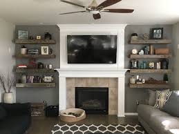 Rustic Living Room Barnwood Floating Shelves Shiplap Fireplace Books And De Floating Shelves Living Room Living Room With Fireplace Farm House Living Room