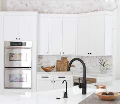 A graphic black and white tile floor, a waterfall quartz topped island and a stunning copper subway tile backsplash give this open kitchen serious style, while smart technology helps make cooking and daily activities easier. Black Beauties A Look At Black Facuets