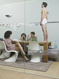 female office workers surveying semi-naked man : rwtfstockphotos