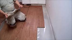 Put all the base cabinets in place, then mark a line on the subfloor corresponding to the front edge of the toekick. How To Install Laminate Flooring On Concrete In The Kitchen Mryoucandoityourself Youtube