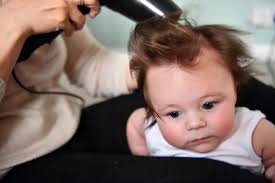 This adorable long-haired baby boy loves having his hair blow-dried