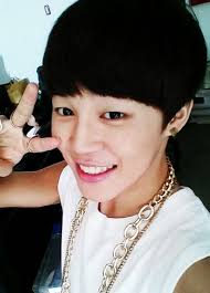 jimin posing with a peace sign by his eyes