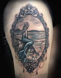 Little Mermaid Girl Sittting On A Rock Looking At The Ocean Tattoo In Ornamental Filligree Frame Ocean Tattoos Mermaid Sleeve Tattoos Mermaid Tattoos