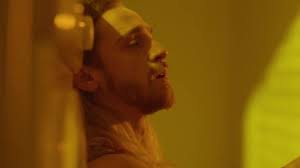 Thoughtful Man Smoking A Cigarette In Room With Yellow Light