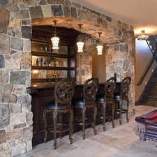 Interior waterproofing — a stone foundation can experience seepage through cracks in the basement floor or at the point where the floor meets the wall, either leak caused by hydrostatic pressure beneath the foundation. Stone Veneer Basement Wall Tile Houzz
