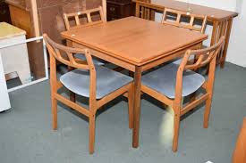The table has extendable leaves. Ansanger Mobler Mid Century Modern Teak Dining Table Plus Four Complimenting Teak Dining Chairs