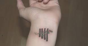 She S Got A Rose Tattoo But She Keeps It Covered I Now Want This Tattoo Really Bad 5sos Tattoo Band Tattoo Tattoos