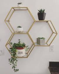 Whether you're using slats to form a tropical rainforest, oscillating colors to create a pastel rainbow or using rough stone materials to convey the aura of the ancients, there's an accent wall to fit every sleeping space's needs. Gold And Glass Honeycomb Wall Shelf Honeycomb Wall Glass Shelves Decor Gold Wall Decor