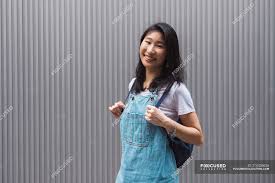 The student body community colleges awarding the most associate degrees to asian american students. Young Asian College Student Posing Against Grey Wall Millennials Half Body Stock Photo 214435626