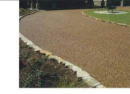 Many people are choosing to use loose materials for their driveway because in most cases, they're more affordable. Pebble Stone Driveway For The Home Pinterest Stone Driveway Driveway Landscaping Front Yard Landscaping