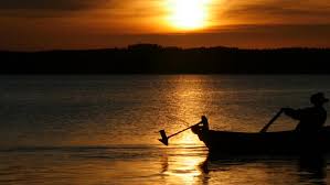 A silhouette of a father and son fishing of the rocks in ireland. Beautiful Sunset Over Lake And Silhouette Of Man Fishing From Boat By Mgpremier