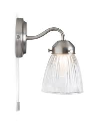 Specifically designed to add ambient lighting in a variety of spaces, more of today's wall sconces and wall lamps are specifically shaped to add dramatic up and downlighting effects, really adding depth and structure to a room. La Parisienne Satin Nickel Bathroom Wall Light With Shade Pull Cord