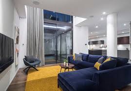 20 Appealing Living Rooms With Gold And Navy Accents Home Design Lover Blue Sofas Living Room Yellow Decor Living Room Navy Living Rooms