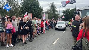 Hundreds of protesters gather at asylum hotel in Norwich area - BBC News