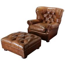 Both a comfy armchair with low wide rolled out arms, a thick seat and a wide back and a rectangular ottoman have elegant upholstery of leather in warm browns. Large Vintage Ralph Lauren Brown Leather Armchair With Matching Ottoman 1stdibs Com Brown Leather Armchair Leather Armchair Armchair With Ottoman
