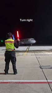Have you ever wondered how planes know where to park? ✈️ Air marshals use  glowing batons and specific signals to guide pilots to the gate, ensuring a  safe and seamless arrival. Watch this video to see ...