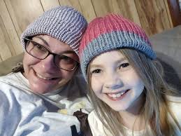 Making hats for the homeless shelter with a cub scout