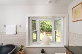 Floor to ceiling light gray wainscoting in master bathroom adds a classic finish to the walls completed with a modern freestanding tub paired with a floor mount chrome tub filler. Budget Friendly Bathroom Tiles For A Cabin Remodel Fireclay Tile