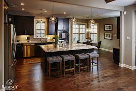 Natural and indoor lighting play a huge part in keeping the right balance between light and dark. Regency Homebuilders Open Concept Living Open Kitchen Pendant Lighting Recessed Trendy Kitchen Tile Dark Cabinets Kitchen Ideas Dark Cabinets Open Concept