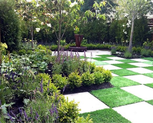French-inspired courtyard with gravel paths stone planters and climbing greenery