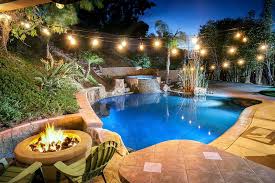 Give your family the option of a healthy activity, a safe place to play and exercise in the comfort of your own backyard without worrying about where they are. A Beautifully Lit And Landscaped Backyard With A Basketball Court Pool Waterfall Jacuzzi Waterslide And Firepit By Eddie Bojorquez Photo Stock Snapwire