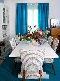 A Bright Aquamarine Rug Curtains Contrast Nicely Against The Word Printed Fabric Di Colorful Living Room Design Colourful Living Room Colorful Bedroom Design