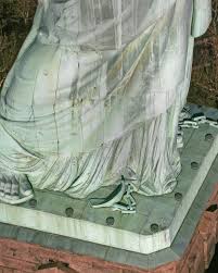 Did you know the Statue of Liberty is stepping forward? The Statue's raised  right heel is meant to symbolize the forward movement of liberty. Broken  shackles at her feet represent a fuller