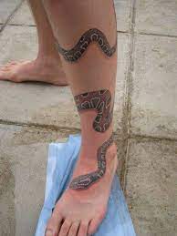 Black rat snake chasing a vole with magnolia flowers on inner upper arm. Pin By Tai Speight On Eye Catching Tattoos Around Arm Tattoo Leg Tattoos Snake Tattoo Design
