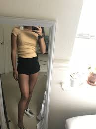 Black And White Checkered Vans With Black Stripe Yellow And White Striped Off The Shoulder Top Crime Bralette Black Shorts Checkered Slip On White Vans Outfit Checkered Vans Outfit Black Jean Shorts Outfit