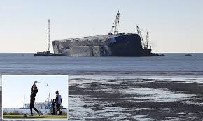 overturned cargo ship sinking in the