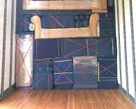 Gambar Boss Cargo team carefully packing and loading furniture into a truck