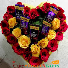 Roses are emotive flowers that can hold deep meaning and stir feelings. Dairy Milk Chocolate And Rose Flower Heart Shape Arrangement Cakeflowerngifts Com