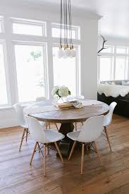 Eat In Kitchen Boasts A Schoolhouse Electric Brass City Chandelier 7 Illuminates A Round Salvaged Wood Di Farmhouse Dining Room Eames Dining Chair Eames Dining