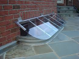 A window well cover is a sheet of material manufactured to fit over the top of an exposed window well to cover the well and basement window. Slanted Window Well Cover To Repel Rain Snow And Debris Made To Fit Any Well I Mean Just Look At The Basement Window Well Window Well Window Well Cover