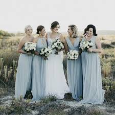 These Bridesmaids Look Fresh Light And Airy Surrounded By Nature In Their Dessygroup Bride Pale Blue Wedding Dark Green Wedding Pale Blue Bridesmaid Dresses