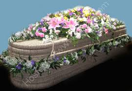 This wicker coffin garland is a beautiful and earthly tribute that are environmentally friendly, with no plastics or cello. Simonis Bournemouth Florist Ltd Decorated Wicker Casket Br Mixed Flowers