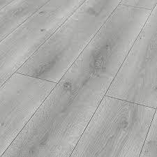 The wood effect planks are stain and water resistant, making them suitable for splash area's such as kitchens and the peel and stick fitting style means there is virtually no mess or dust created when laying these vinyl floor planks. Classen Grey Oak Effect Laminate Flooring 1 97m Pack Diy At B Q