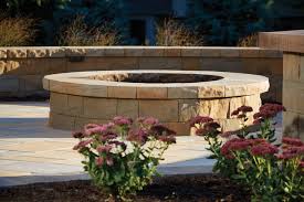 This fire pit utilizes flagstones for its design and goes nicely with any retaining wall features you might have in your yard. Picturesque Patio Fire Pit Created From Concrete Retaining Wall Blocks Transitional Patio Minneapolis By Anchor Block Company Houzz