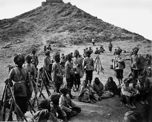 Photograph of a group of Afghan prisoners with a Sikh escort, taken by John Burke in 1878.
