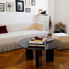 The vintage coffee table has a base made of brass fluted tubing that connects black wood feet and braces, the latter of which holds a rectangular black iron frame upon which the. Coffee Table With Black Lacquered Legs And Smoked Glass Top Carlotta The Socialite Family